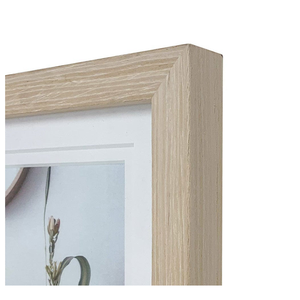 Close-up detail of light birch wood frame corner showing grain texture and beveled edge design with matted artwork visible inside.