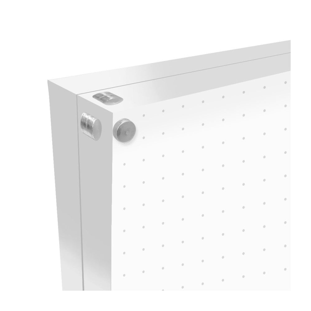 Close-up side view of a clear acrylic photo block showing its edge, metal mounting hardware, and perforated surface for hanging.