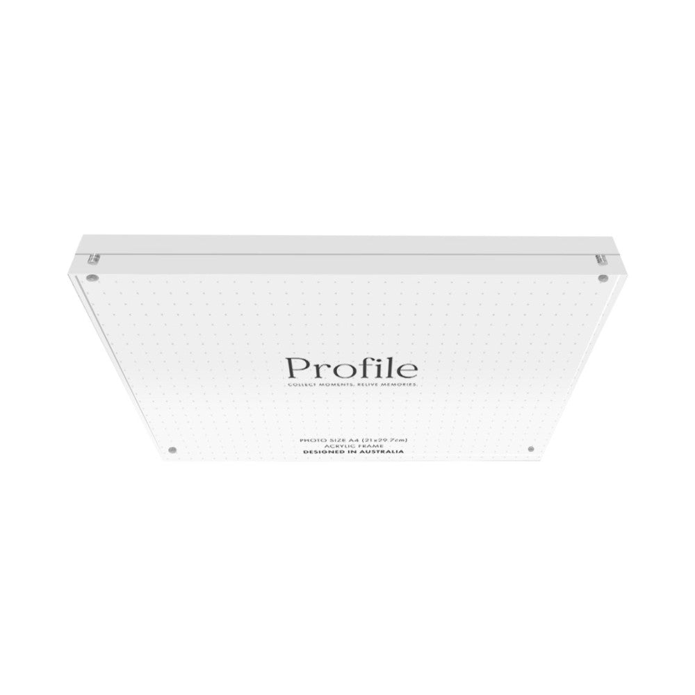 Rear view of a clear acrylic photo block showing the back panel with Profile branding, product specifications, and four mounting holes against a white background.