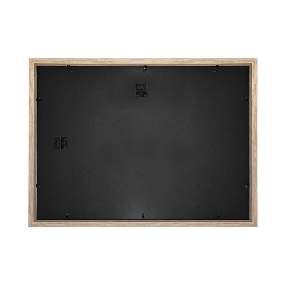 Rear view of a natural wood-framed picture frame showing the black backing, hanging hardware, and mounting clips.