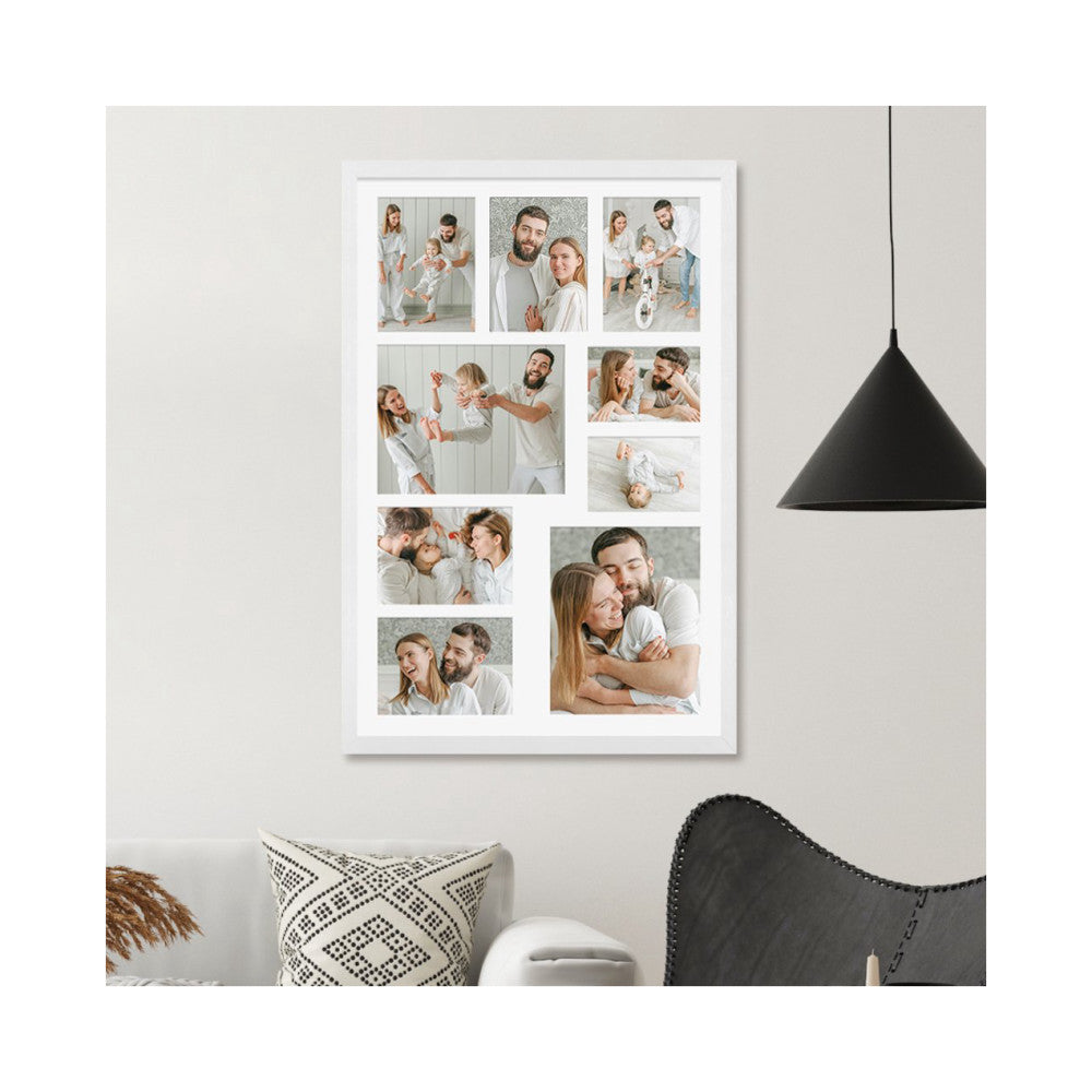 White multi-photo frame displaying nine family portraits hung on a beige wall above a patterned pillow and black chair.