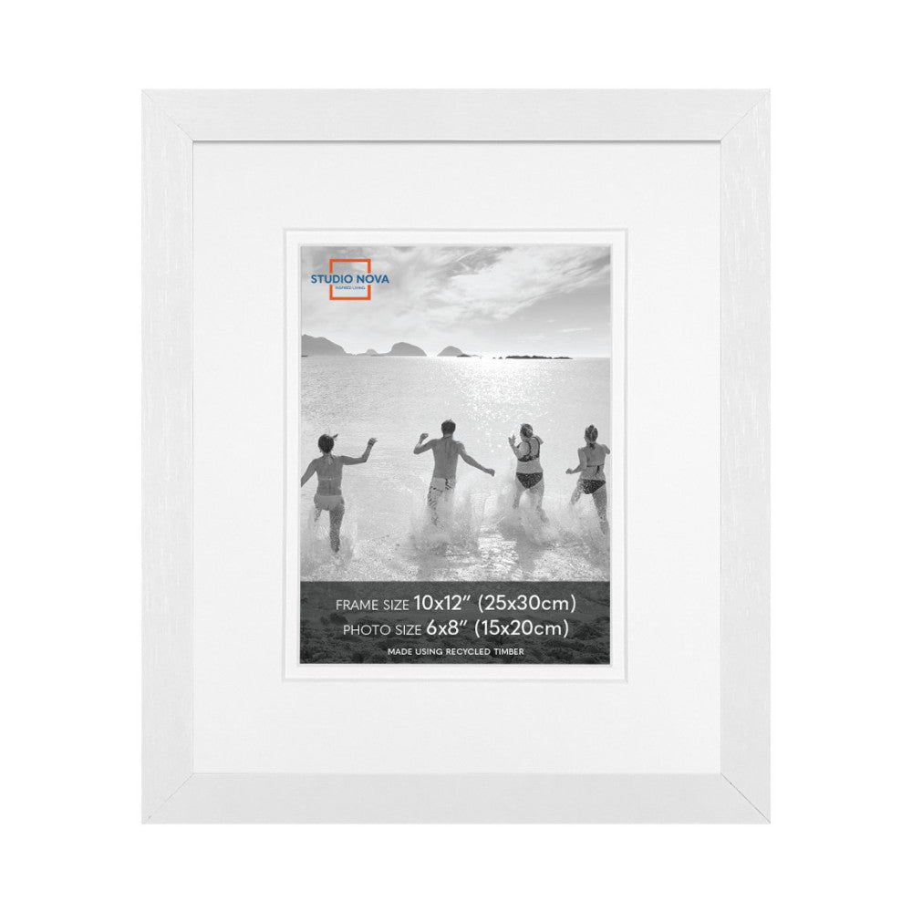 White wooden frame displaying a black and white beach photo with four people running into the ocean, shown straight-on.