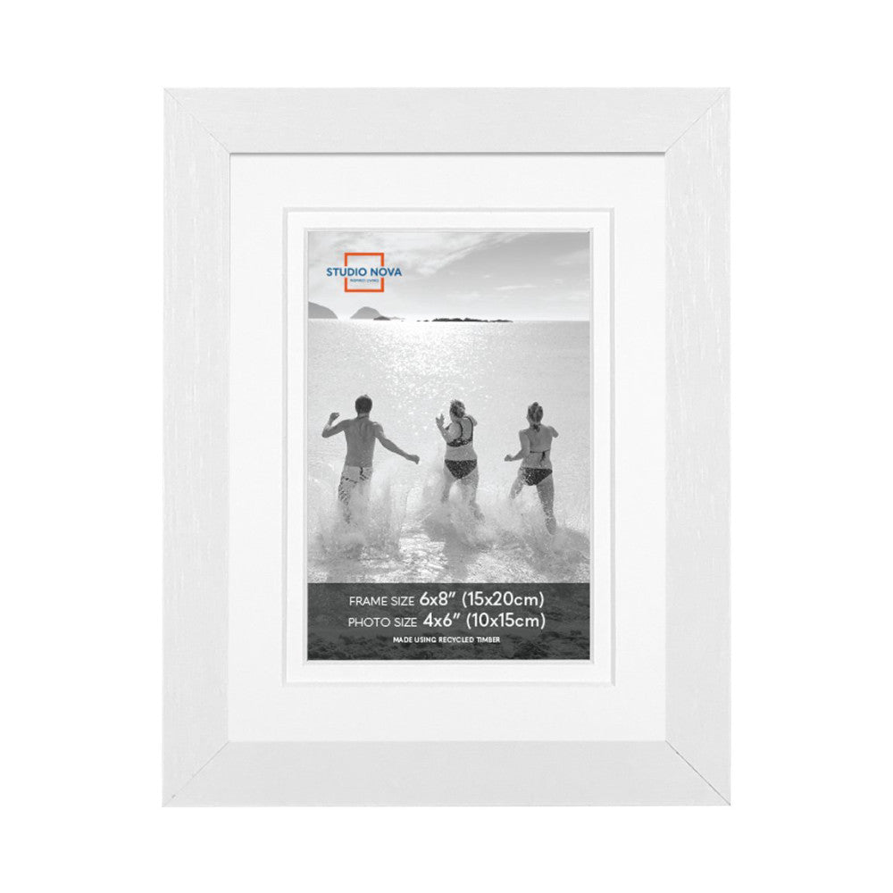 White picture frame displaying a black and white beach photo of three people running into the ocean, shown front view against white background.