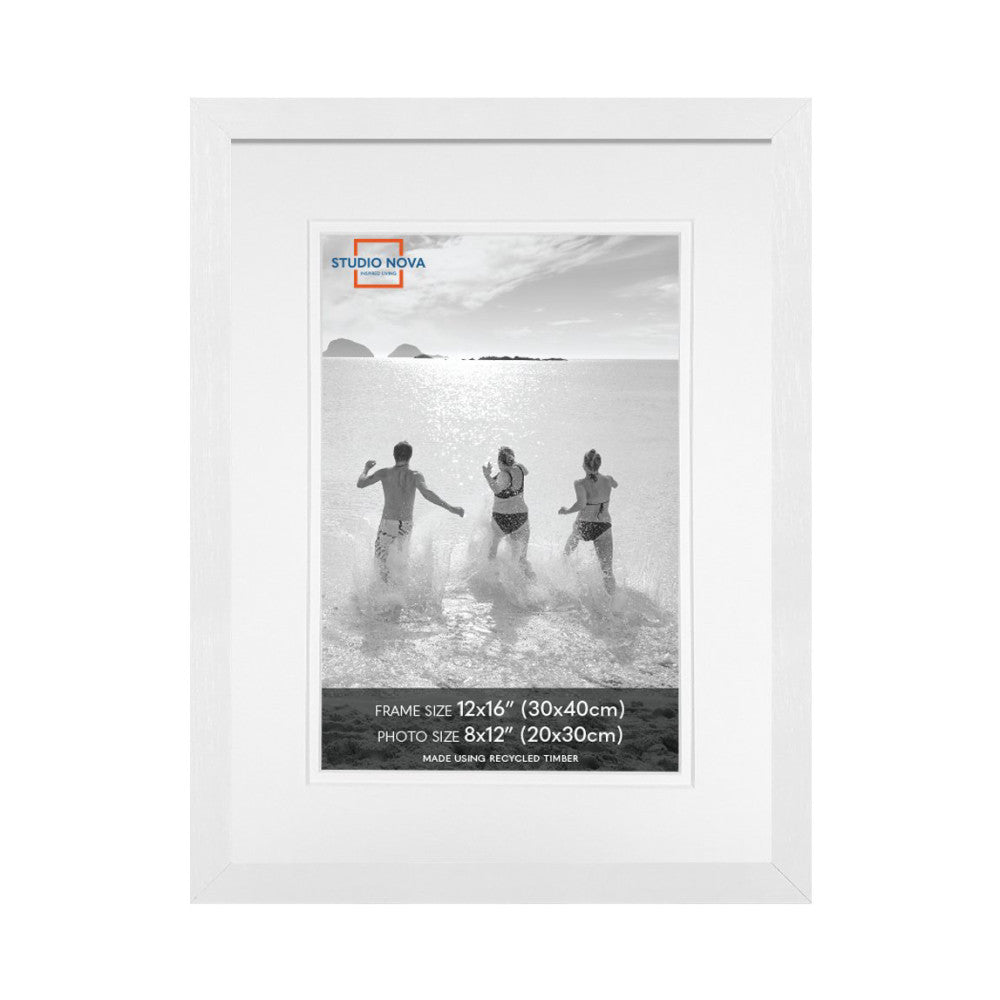White picture frame displaying a black and white beach photo of three people running into the ocean, shown from the front view.