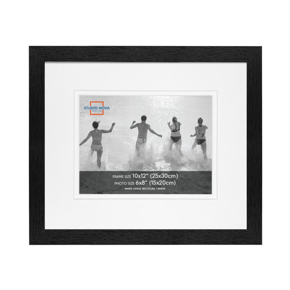 Black wooden frame displaying a matted black and white photograph of people running into ocean waves, showing front view of single frame.