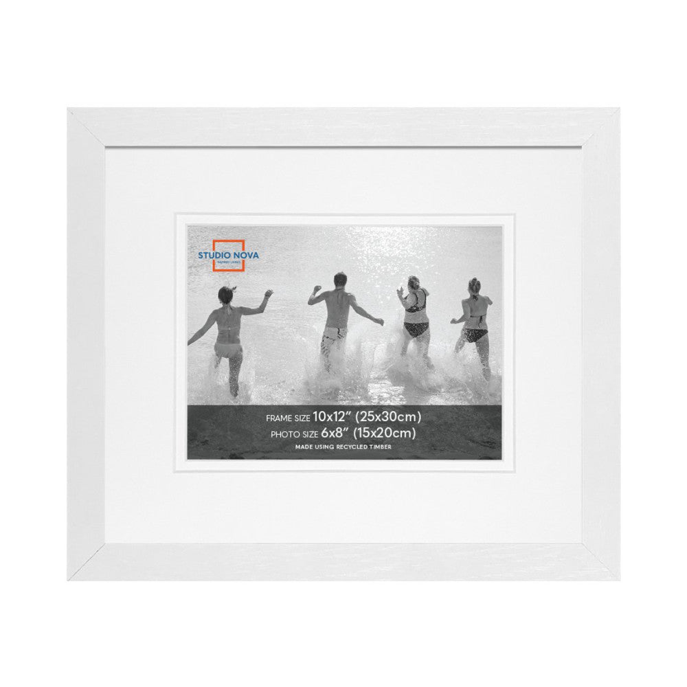 White wooden picture frame displaying a black and white photo of four people running into ocean waves, shown from the front.