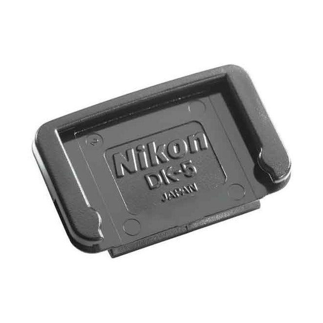 Black Nikon DK-5 eyepiece cover shown at an angled perspective against white background, displaying the embossed Nikon branding and Japan marking on its surface.