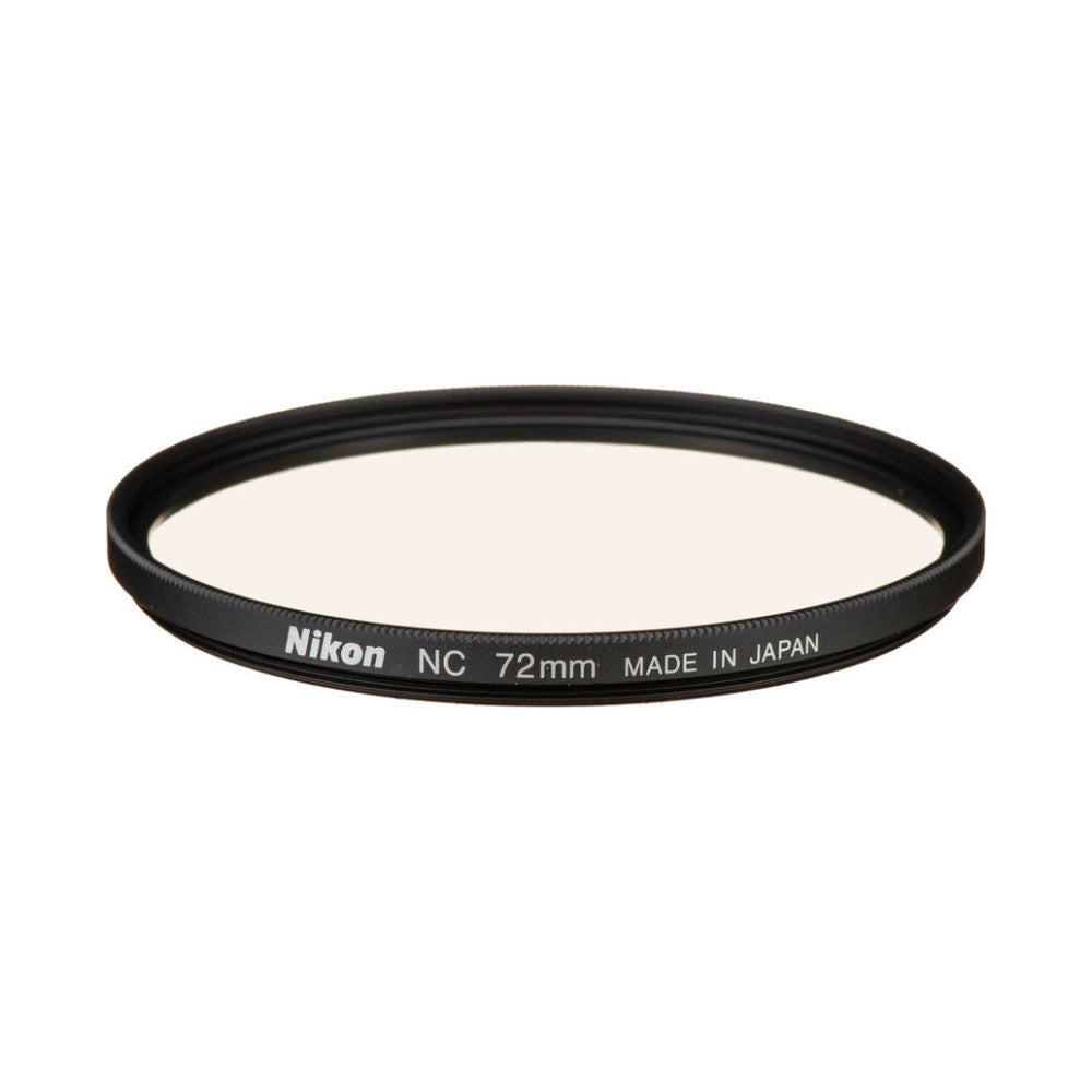 Angled side view of a circular black-rimmed Nikon NC 72mm protection filter showing its clear glass surface and printed text on the frame.