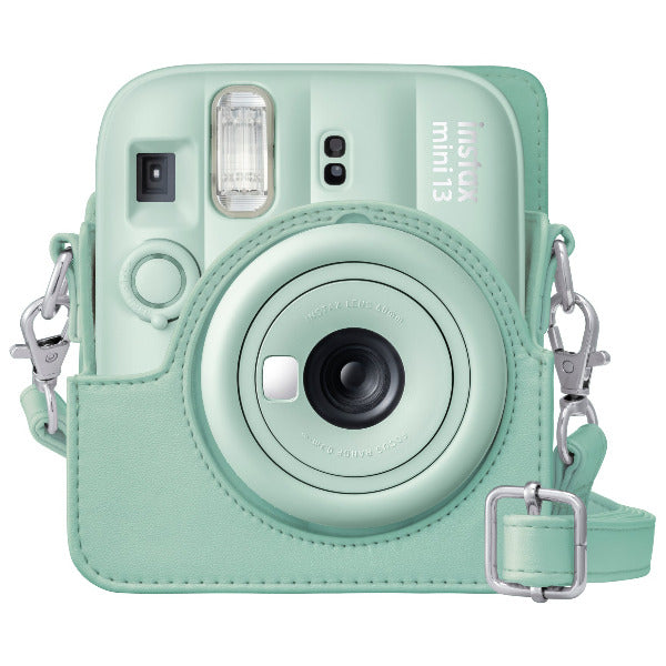 Mint green instant camera with strap on a white background