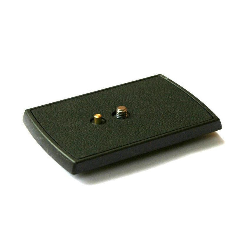 Black rectangular quick release plate shown at an angle, displaying two metal mounting screws on textured surface against white background.