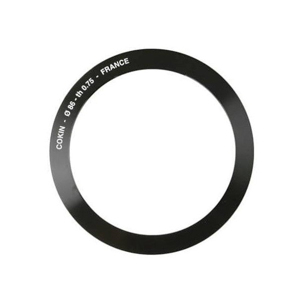 Black circular adapter ring shown from front view with engraved text "COKIN - 0.86 - 11/073 - FRANCE" visible on the outer edge against white background.