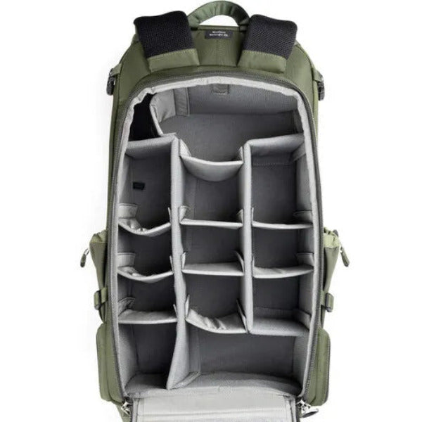 Green backpack with interior compartments on a white background